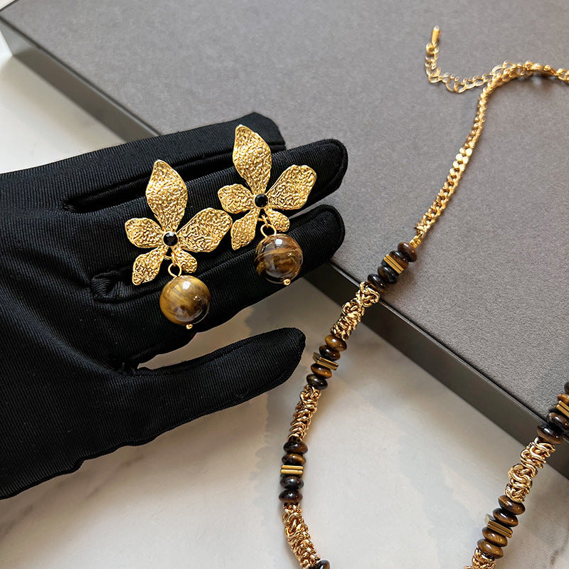 Gold plated tiger eye stone necklace with long sweater chain and floral-inspired design
