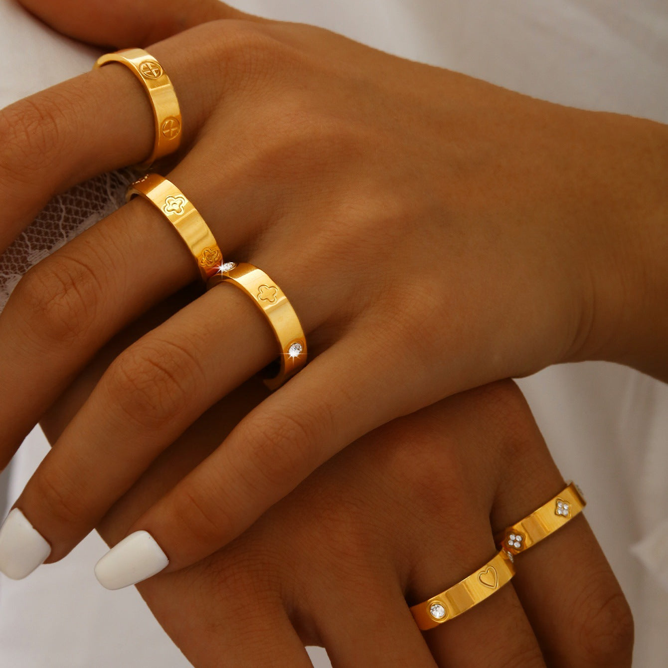 Gold plated clover heart ring set with stackable geometric stainless steel design
