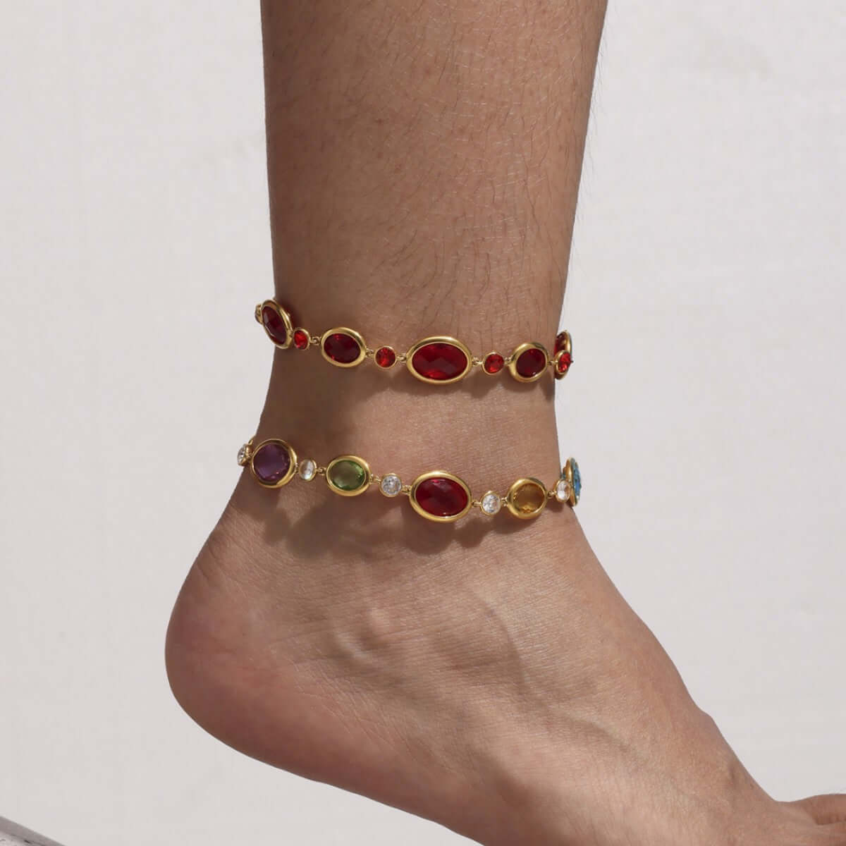 18K gold plated Czech crystal anklet showcasing sparkling red and green stones on a woman&