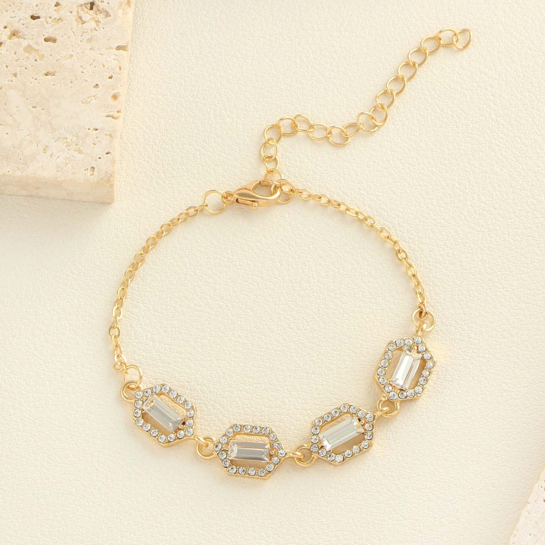 Rhinestone geometric anklet set showcasing a gold layered bracelet with sparkling stones and a stylish clasp.