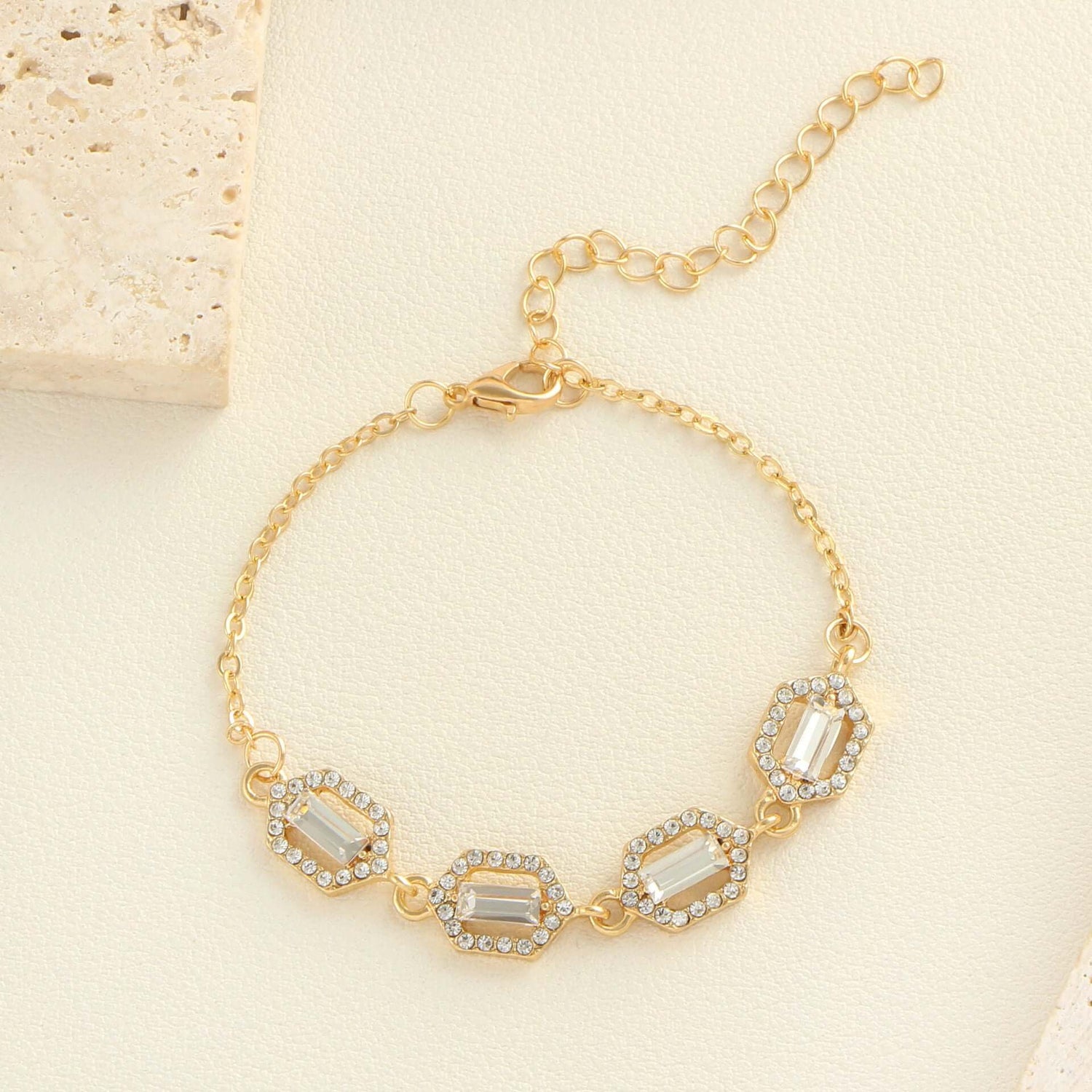 Rhinestone geometric anklet set showcasing a gold layered bracelet with sparkling stones and a stylish clasp.