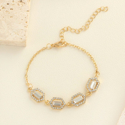 Rhinestone geometric anklet set showcasing a gold layered bracelet with sparkling stones and a stylish clasp.