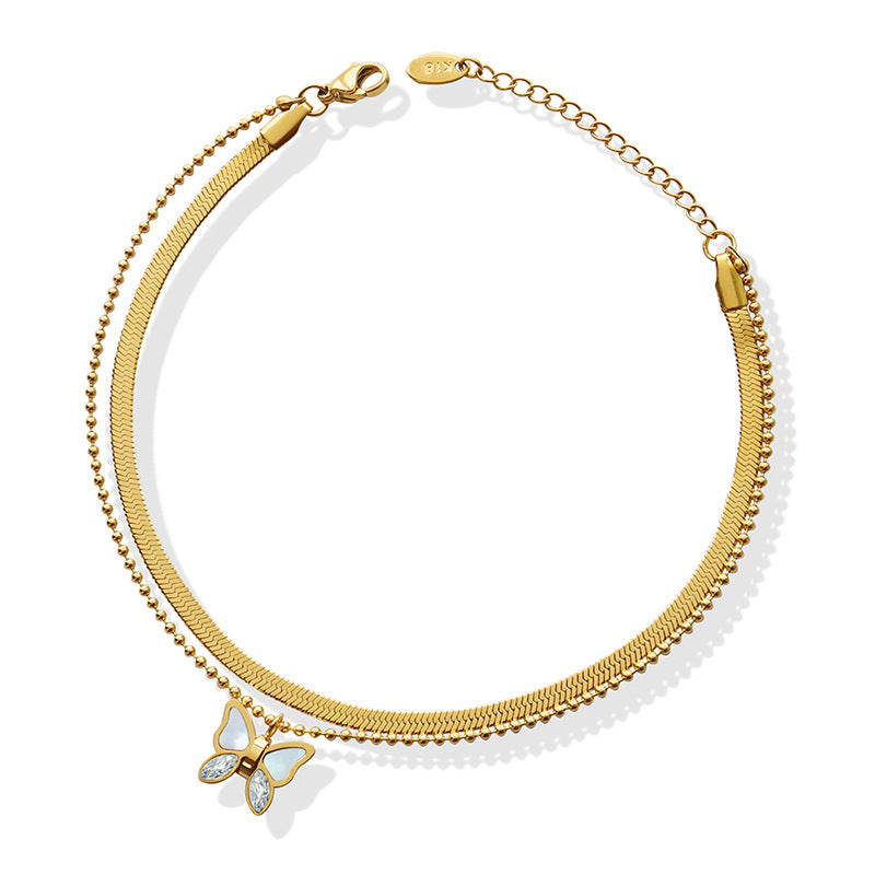 Gold plated butterfly anklet with zircon charm, shell accent, and double-layer snake chain