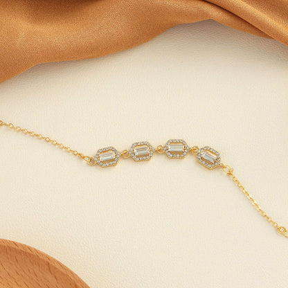 Rhinestone geometric anklet set featuring four elegant layered designs in stainless steel.