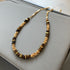 Gold plated tiger eye stone necklace with long sweater chain and floral-inspired design