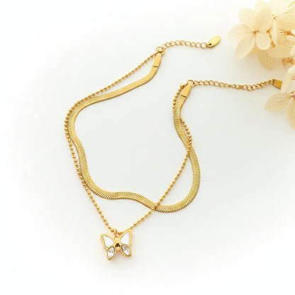 Gold plated butterfly anklet with zircon charm, shell accent, and double-layer snake chain