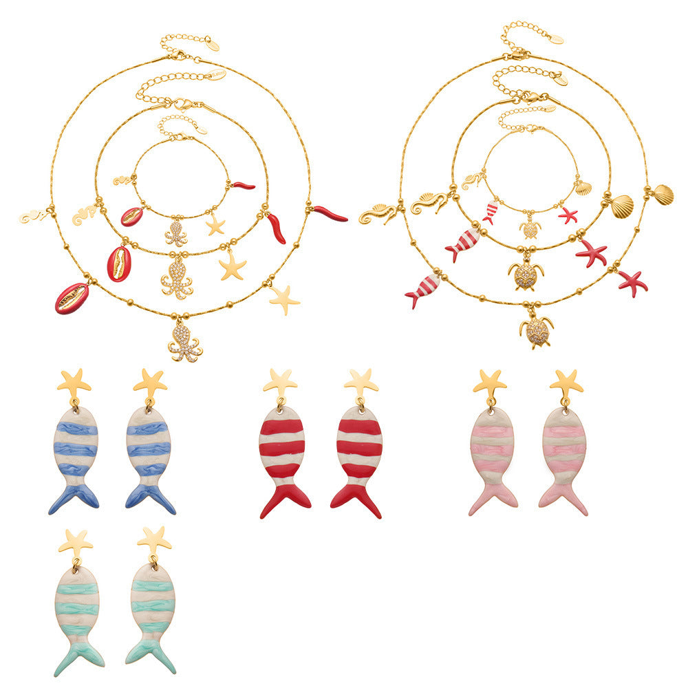 Gold plated ocean charm jewelry set featuring whimsical fish and starfish designs in multiple colors and styles.