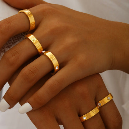 Gold plated clover heart ring set with stackable geometric stainless steel design