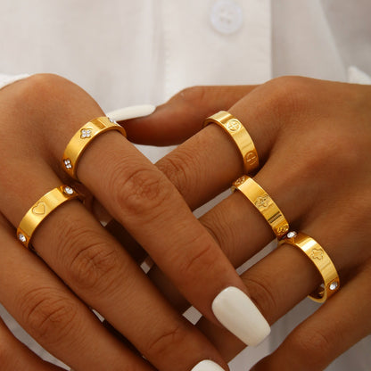 Gold plated clover heart ring set with stackable geometric stainless steel design