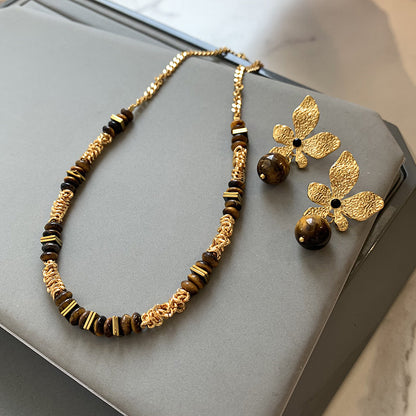 Gold plated tiger eye stone necklace with long sweater chain and floral-inspired design