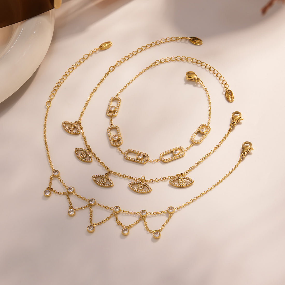 Gold plated zircon bracelet set with starburst chain links and sparkling stone accents