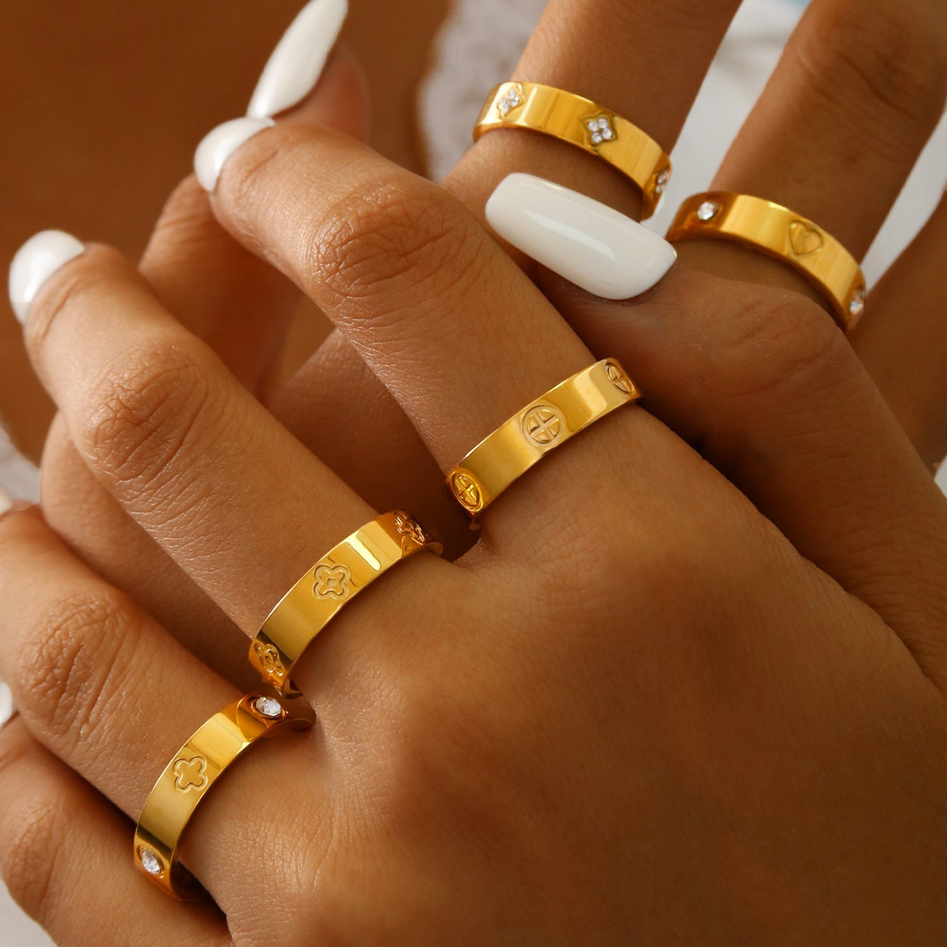 Gold plated clover heart ring set with stackable geometric stainless steel design