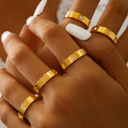 Gold plated clover heart ring set with stackable geometric stainless steel design